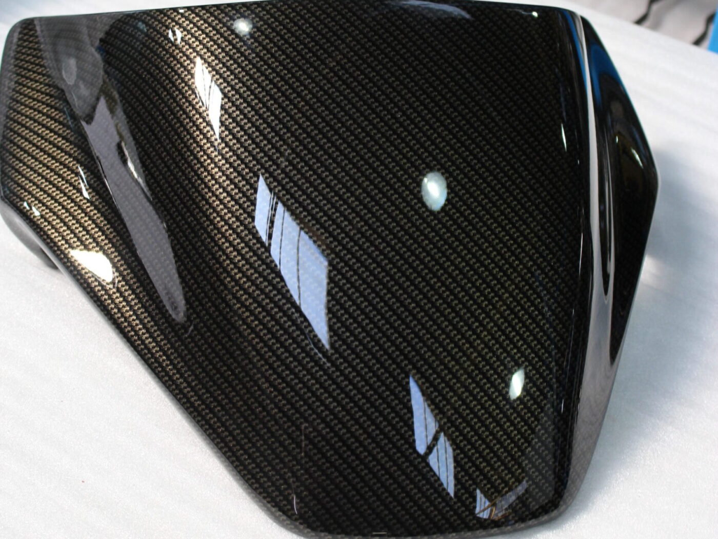 Motorbike parts coated in carbon fibre hydrographic film painted black
