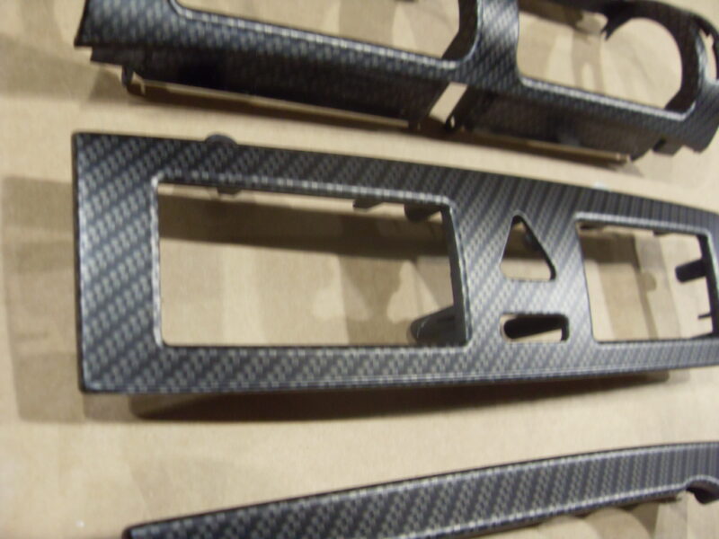 Car dashboard elements coated in carbon fibre hydrographic film painted black