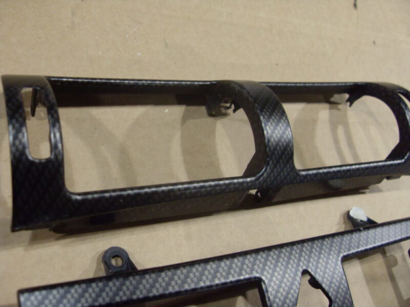 Car dashboard elements coated in carbon fibre hydrographic film painted black