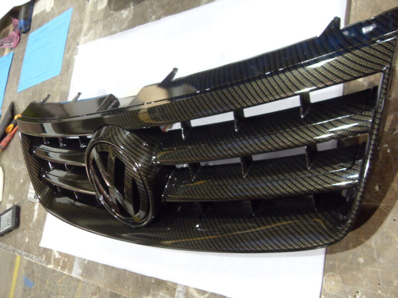 VW radiator cover coated in carbon fibre hydrographic film painted black