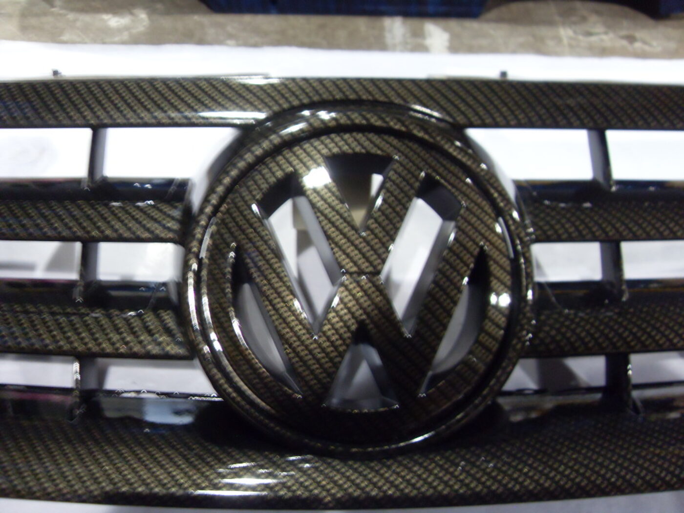 VW radiator cover coated in carbon fibre hydrographic film painted black