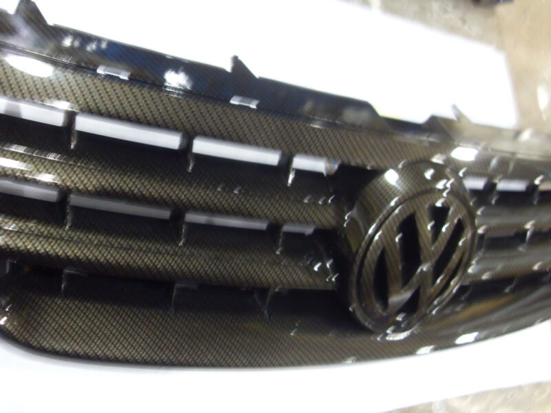 VW radiator cover coated in carbon fibre hydrographic film painted black
