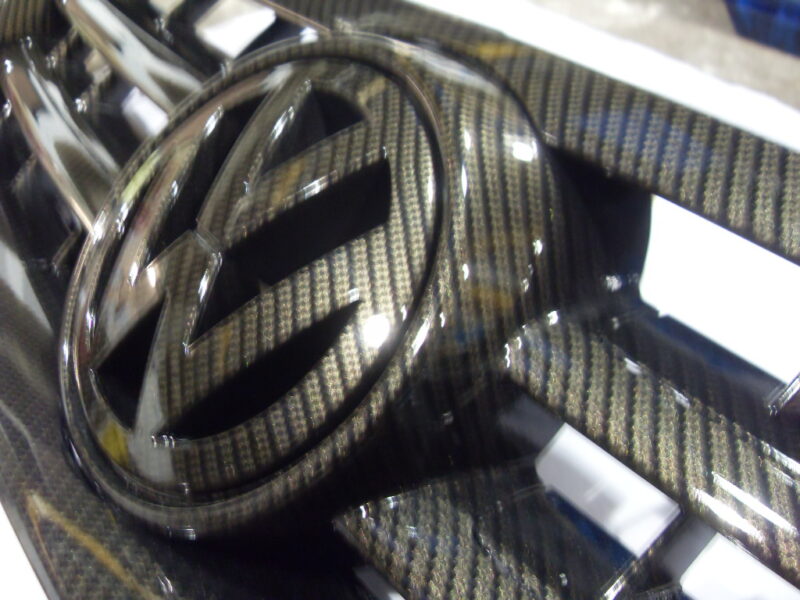 VW radiator cover coated in carbon fibre hydrographic film painted black