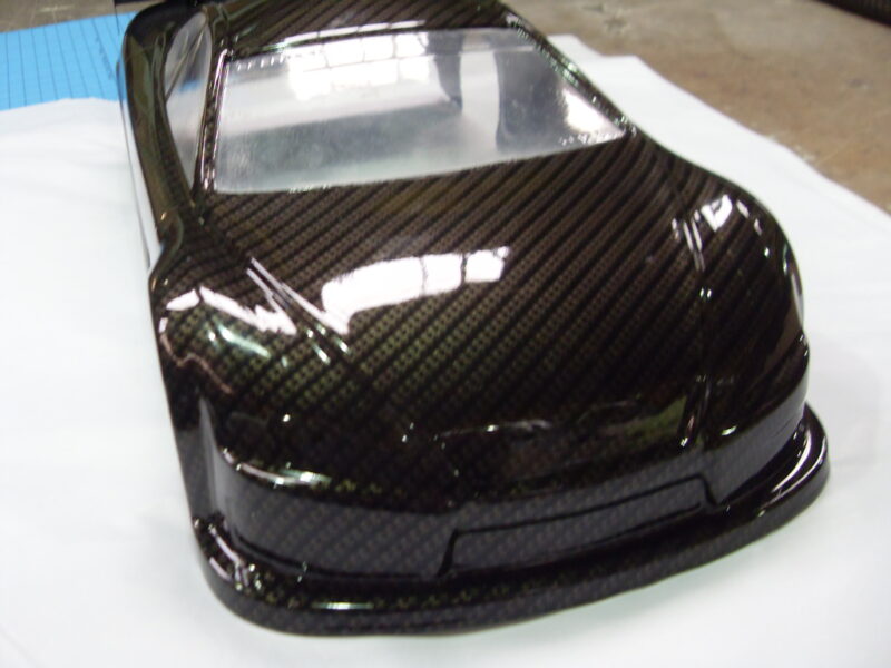 Car exterior model coated in carbon fibre hydrographic film painted black
