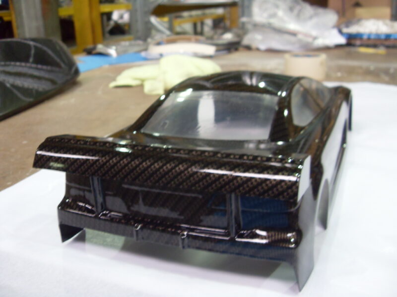 Car exterior model coated in carbon fibre hydrographic film painted black