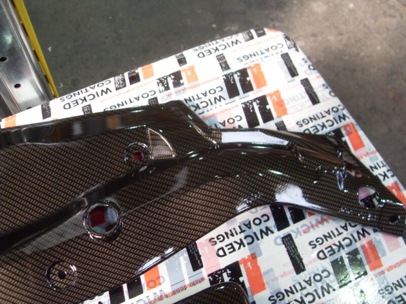 Honda engine parts coated in carbon fibre hydrographic film painted black