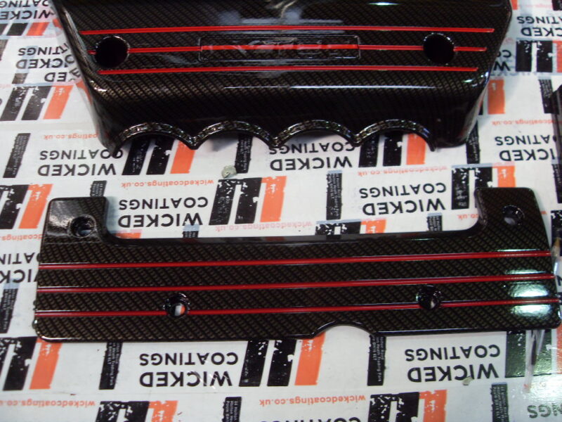 Honda engine parts coated in carbon fibre hydrographic film painted black