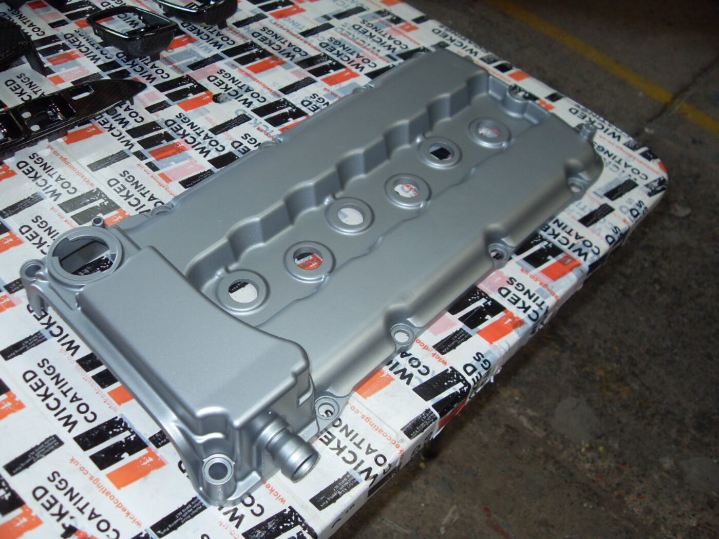 Car engine cover coated in metal hydrographic film