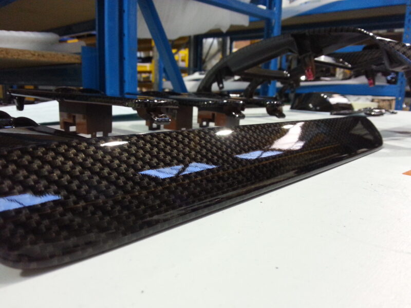Car dashboard parts coated in carbon fibre hydrographic film painted black