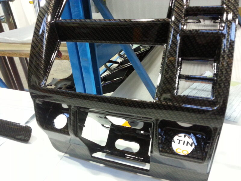 Car dashboard parts coated in carbon fibre hydrographic film painted black