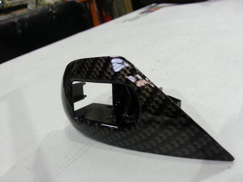 Car dashboard coated in carbon fibre hydrographic film painted black