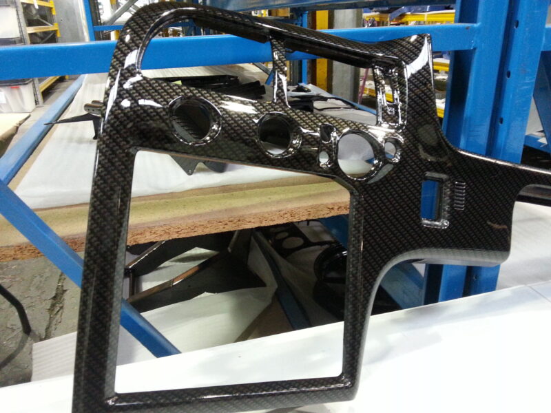 Car dashboard coated in carbon fibre hydrographic film painted black