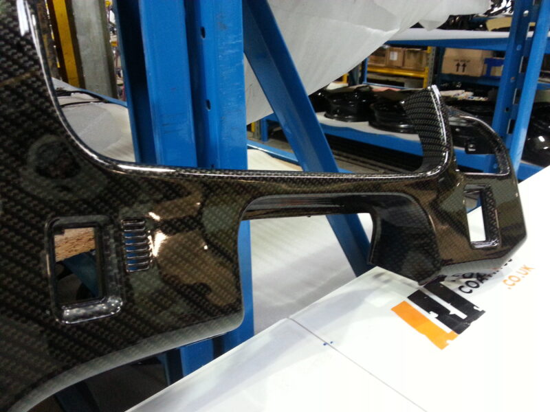 Car dashboard coated in carbon fibre hydrographic film painted black