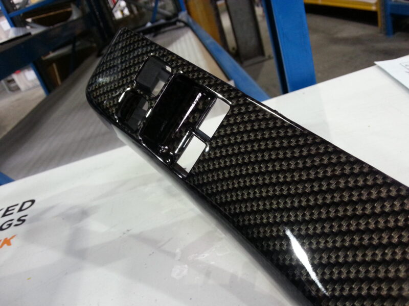 Car dashboard coated in carbon fibre hydrographic film painted black