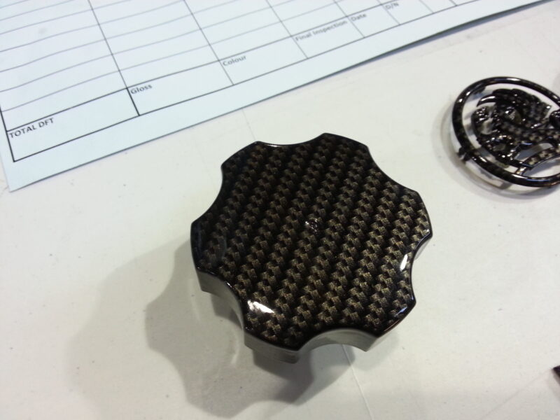 Vauxhall car badge coated in carbon fibre hydrographic film painted black