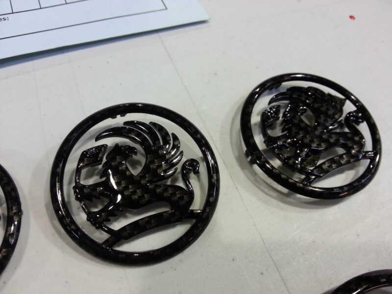 Vauxhall car badge coated in carbon fibre hydrographic film painted black