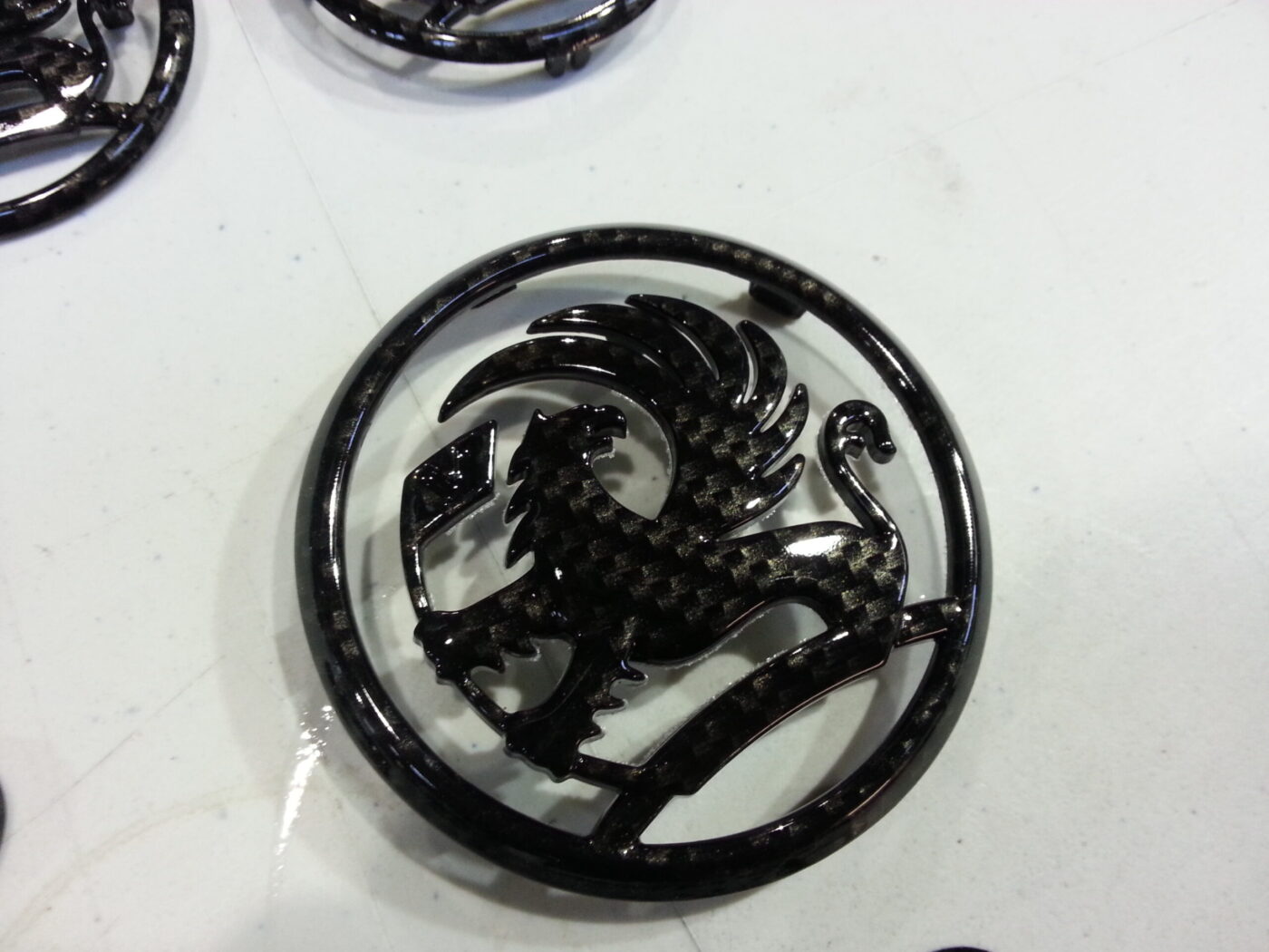 Vauxhall car badge coated in carbon fibre hydrographic film painted black