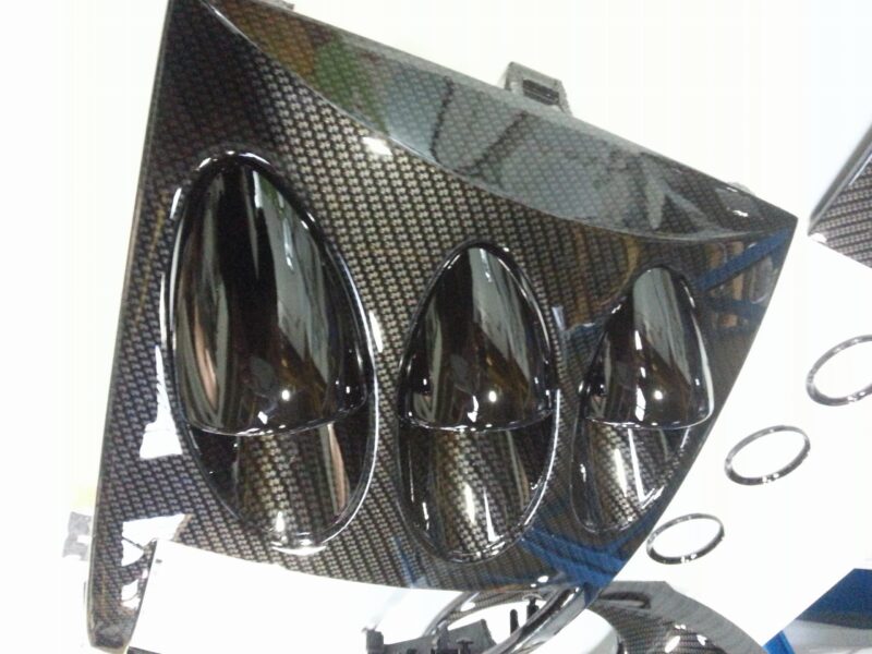 Car dashboard elements coated in carbon fibre hydrographic film painted black