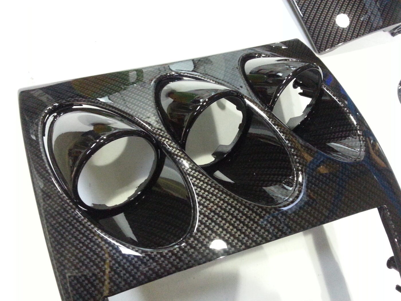 Car dashboard elements coated in carbon fibre hydrographic film painted black