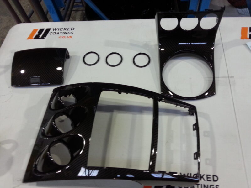 Car dashboard elements coated in carbon fibre hydrographic film painted black