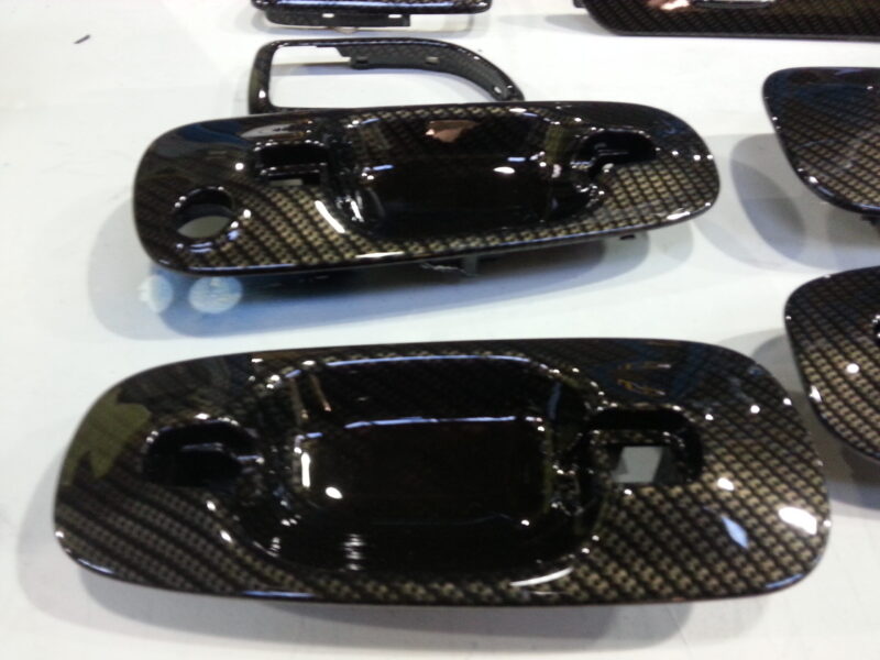 Car interior various elements coated in carbon fibre hydrographic film painted black