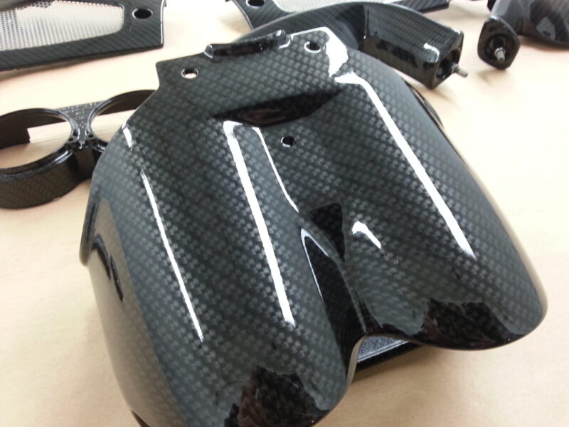 Motorbike elements coated in carbon fibre hydrographic film painted black