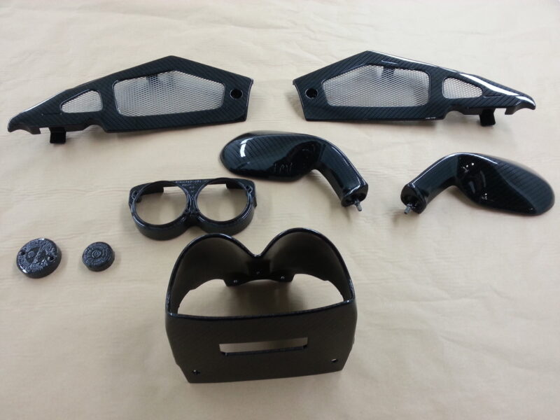 Motorbike elements coated in carbon fibre hydrographic film painted black