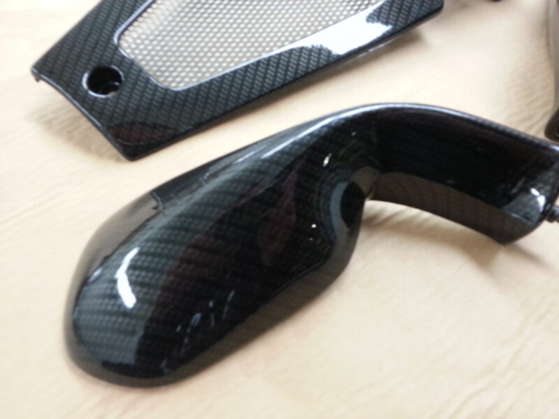 Motorbike elements coated in carbon fibre hydrographic film painted black